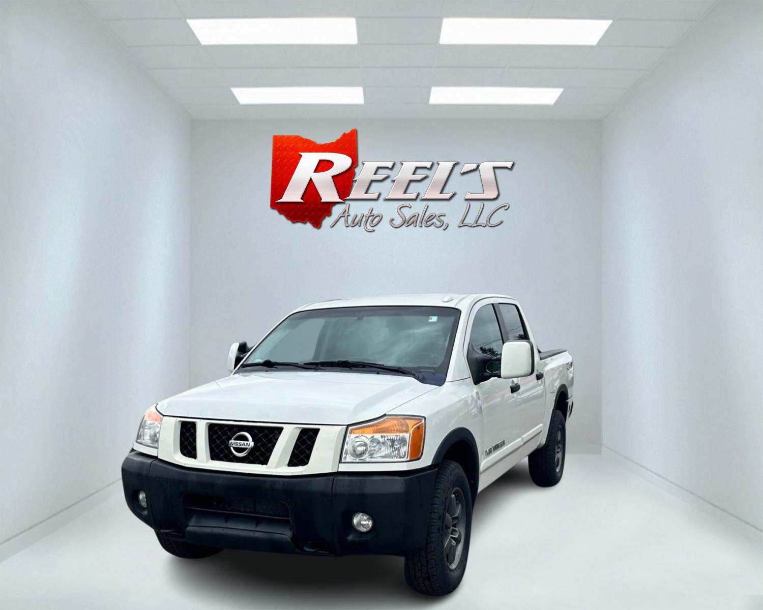 2013 White /Black Nissan Titan Pro-4X (1N6AA0EC0DN) with an 5.6L DOHC 32V V8 engine, Automatic transmission, located at 547 E. Main St., Orwell, OH, 44076, (440) 437-5893, 41.535435, -80.847855 - This 2013 Nissan Titan Pro-4X Crew Cab is a capable and well-equipped full-size pickup truck. It features a powerful 5.6L Endurance V8 engine paired with a 5-speed automatic transmission, a locking rear differential for improved traction, and a maximum towing capacity of 9,300 pounds. The truck is l - Photo #0